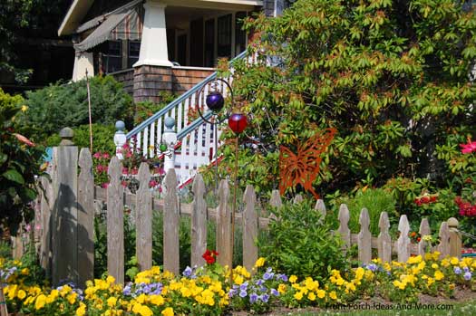 natural looking wood picket fence amongst a flower garden