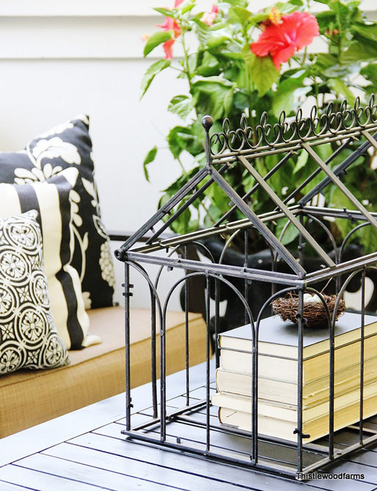 books in birdcage on table