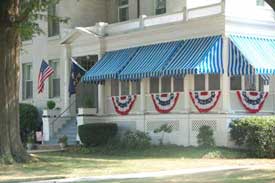 American and Navy flags with buntings on porch