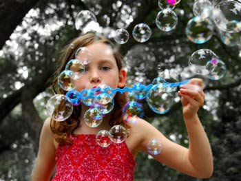 girl blowing bubbles