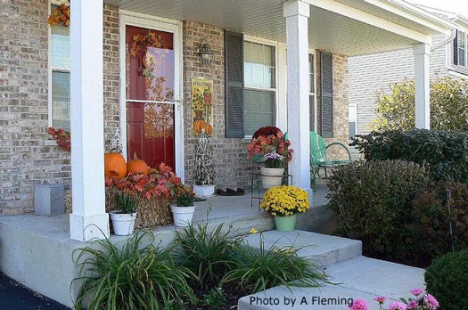 typical decorated fall porch with leaves on straw bale