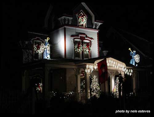 Christmas light idea example - beautiful angels lit up on front of house and 2nd story