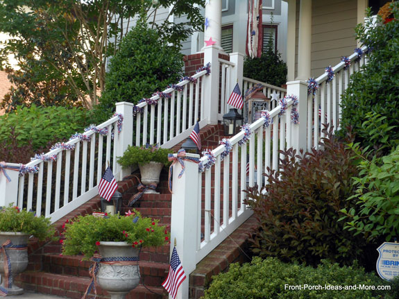 front porch bannister with 4th of July garland