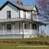 farm house with large wrap around porch