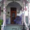 victorian porch with purple trim and furnishings