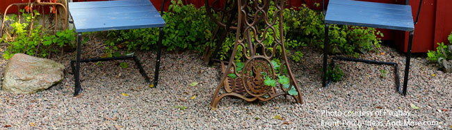 gravel backyard patio with bistro table and chairs