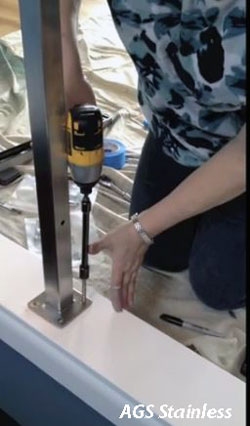 woman installing glass deck railing