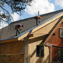 roofers installing a metal roof on a home