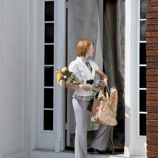 woman entering doorway with an instant screen door installed
