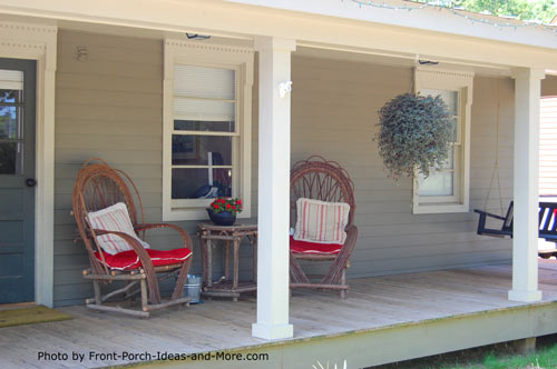 rocking chairs with red cushions on front porch