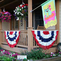 an outdoor decorative flag on fron porch
