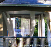 outdoor porch curtains blowing in the breeze