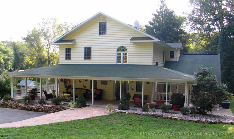 beautiful country style wrap around porch with stone walkway
