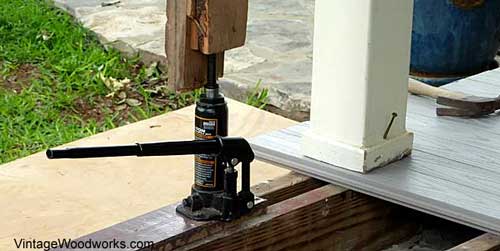 Nail a piece of wood (plywood) to the top of the 2x4s to protect the beam's surface.