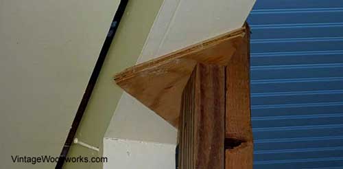 Raise the beam just enough to be able to chisel out the old porch flooring under the post.