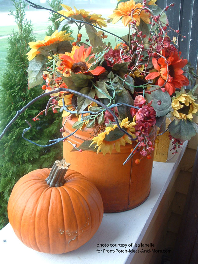scarecrow and pumpkins on porch steps