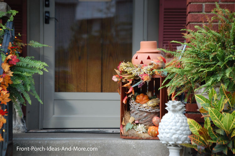 decorative pumpkin on old crate on front porch