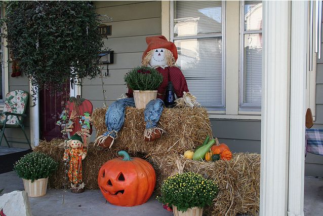 Beautiful Autumn decorated porch with whimiscal scarecrow
