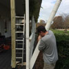 man replacing a porch column