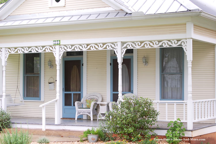 classic wooden screen door and fretwork on front porch