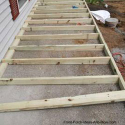 joists being installed on concrete porch floor