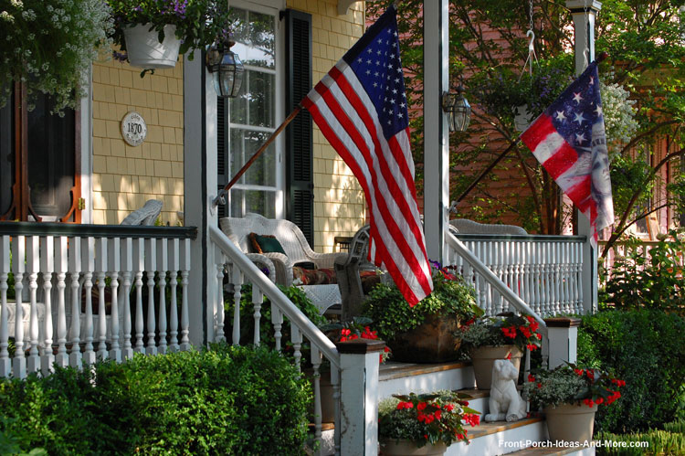 Turned porch balusters on front porch with American flag