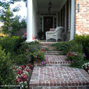 fanciful brick sidewalk leading to front porch