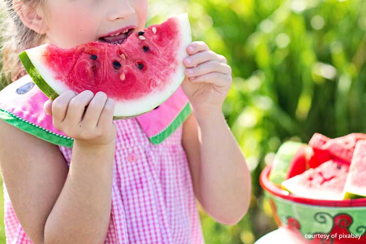 cute girl enjoying watermelon