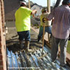 men working to level concrete for front porch floor