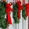three wreaths hanging on front porch