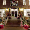 Front door and porch with Christmas lighting and decorations