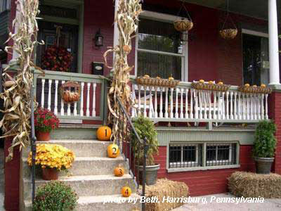 porch steps lined with numbered pumpkins