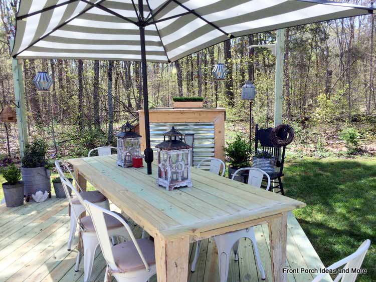 Backyard table with a rectangular shaped umbrella seats a good sized group for a picnic