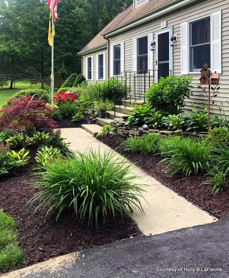 Side view of Holly's home before her new porch. Beautiful landscaping.