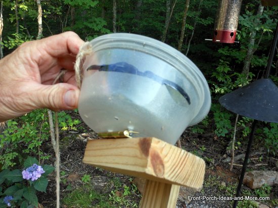 container attached to block of wood