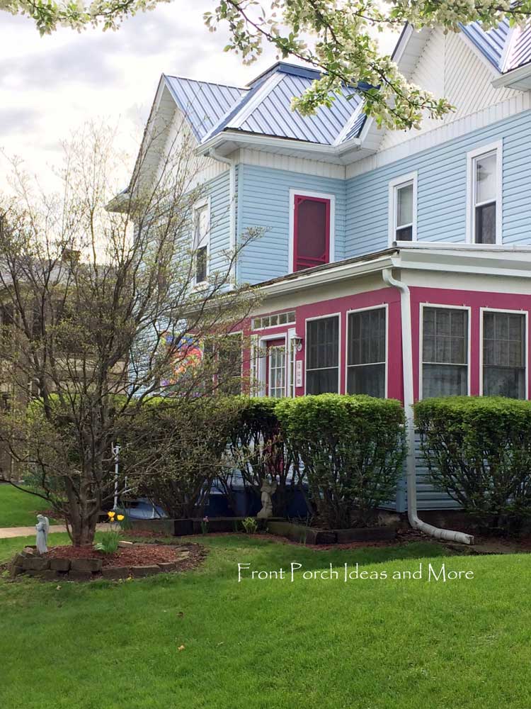 blue and pink house with porch