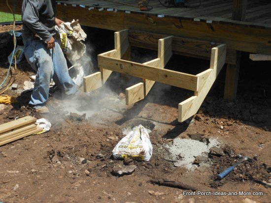 dry concrete is poured into holes for supporting posts