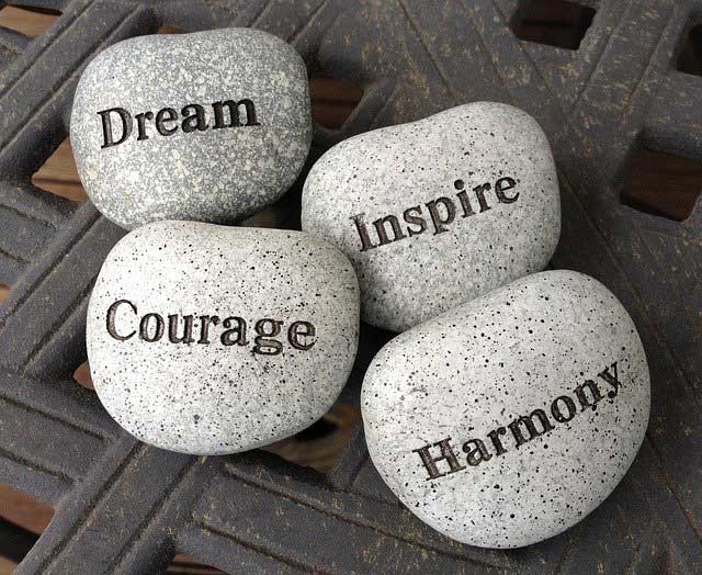 stones with the words dream inspire courage