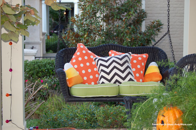 front porch swing with colorful fall cushions