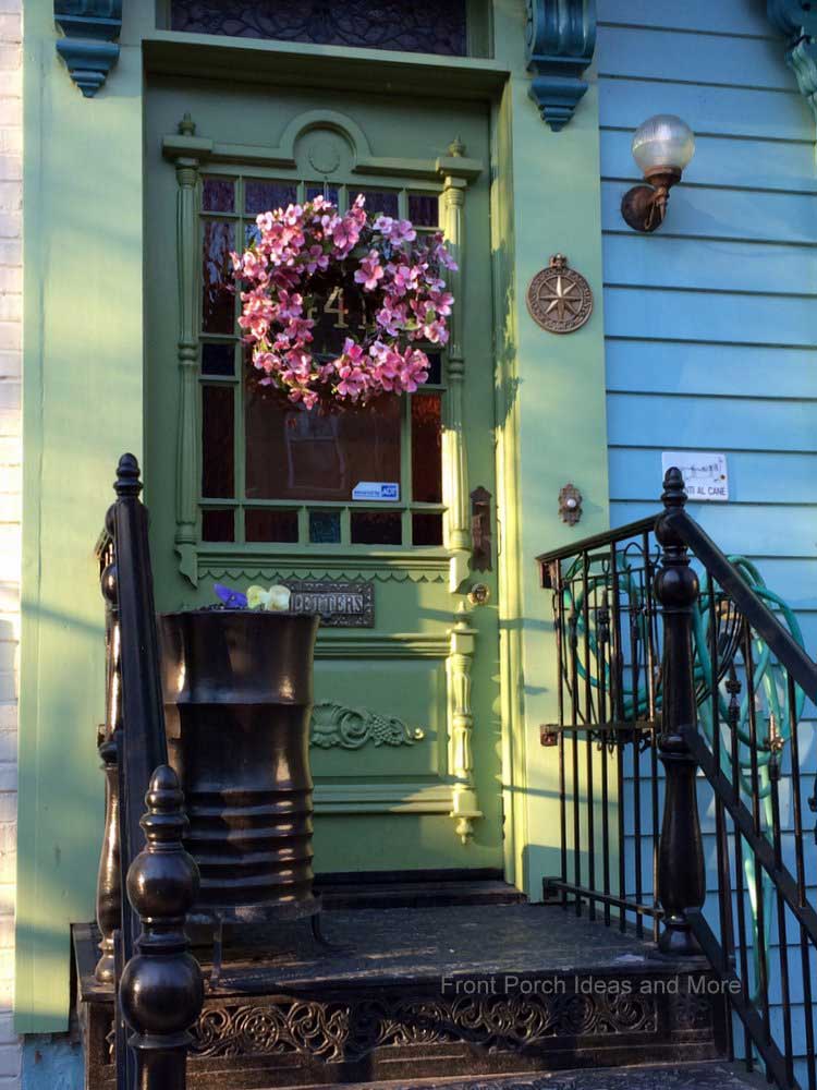 Pink front door wreath on a gorgeous green door