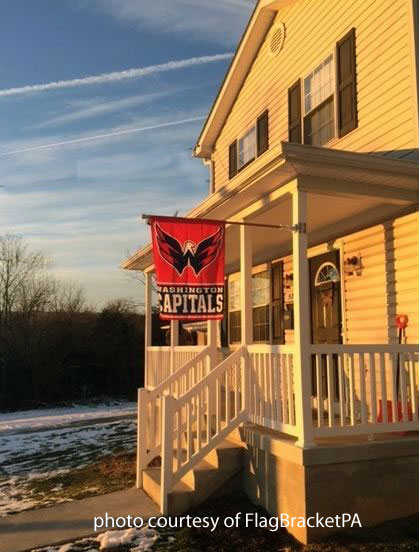flag bracket attached to square front porch column