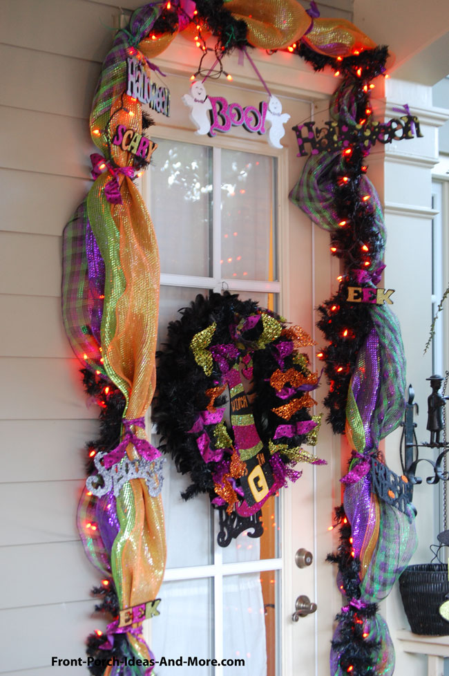 front door on porch decorated for Halloween