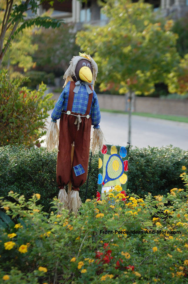 magpie scarecrow in front yard of home