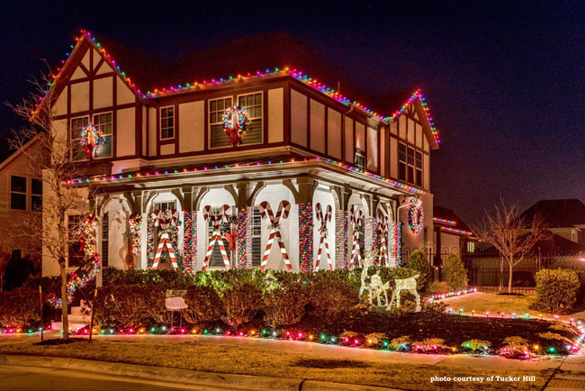 huge candy cane decorations on front porch and amazing Christmas lighting