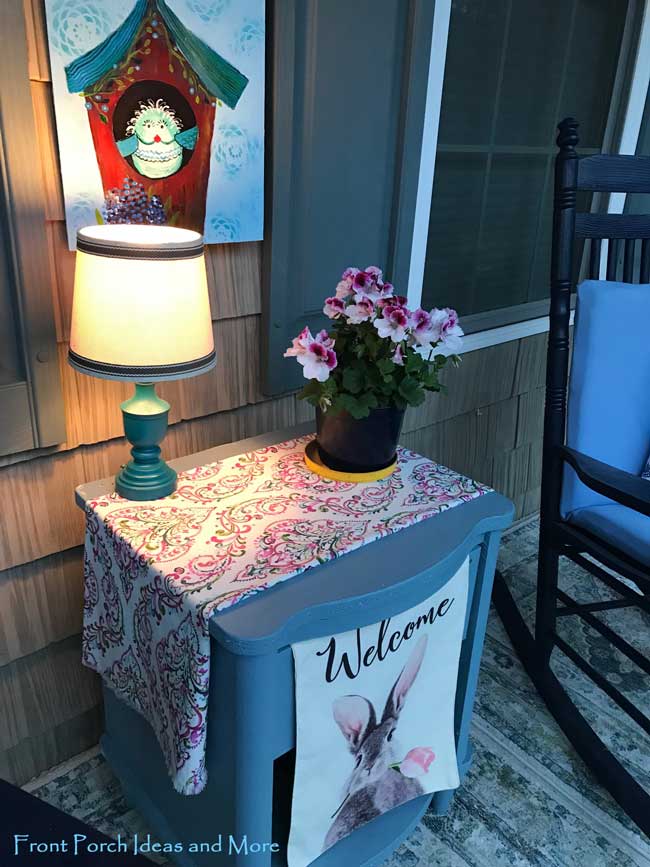 lamp on porch adds ambiance in the evenings
