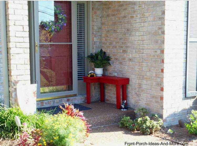 small red bench on front porch