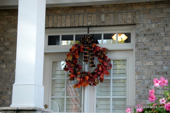 natural fall wreath uses leaf garland and plaid bow