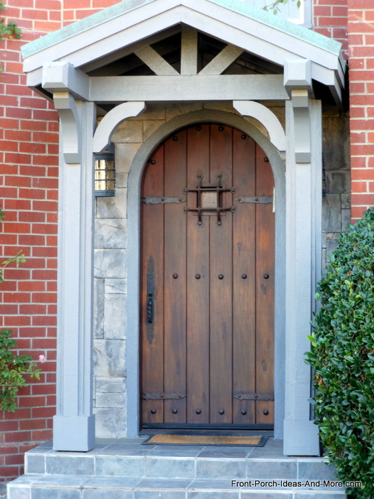 beautiful oval wooden front door with stone trim