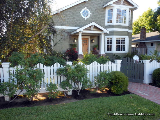picket fence and landscaping add extra appeal to this porch