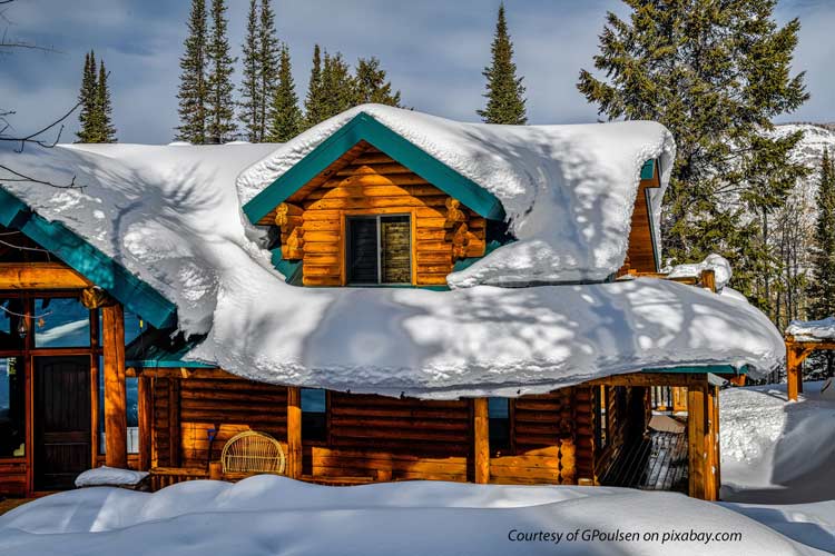 beautiful cabin with snow on roof